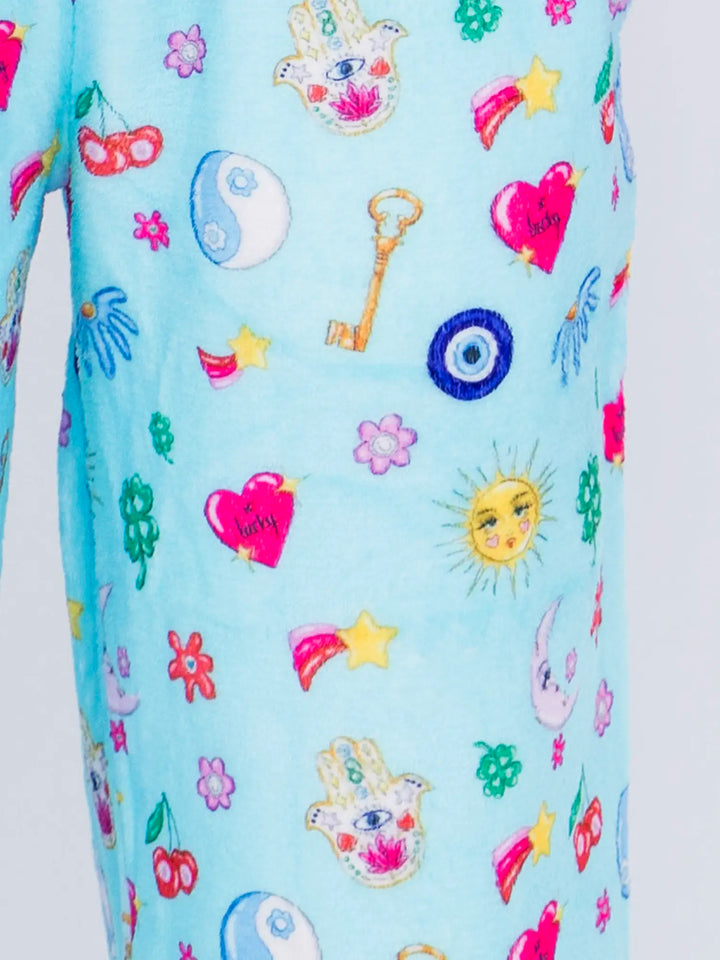 Light blue fabric with colorful lucky charm patterns on a white background