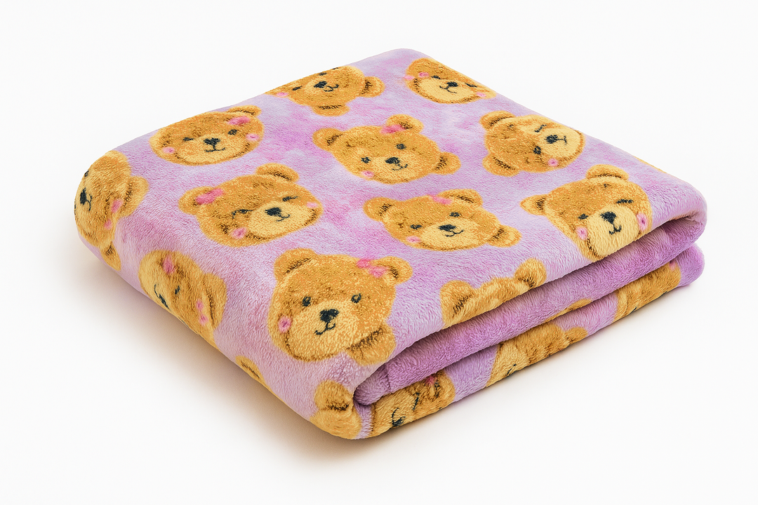 Folded blanket with teddy bear pattern on a lavender background