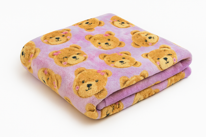 Folded blanket with teddy bear pattern on a lavender background