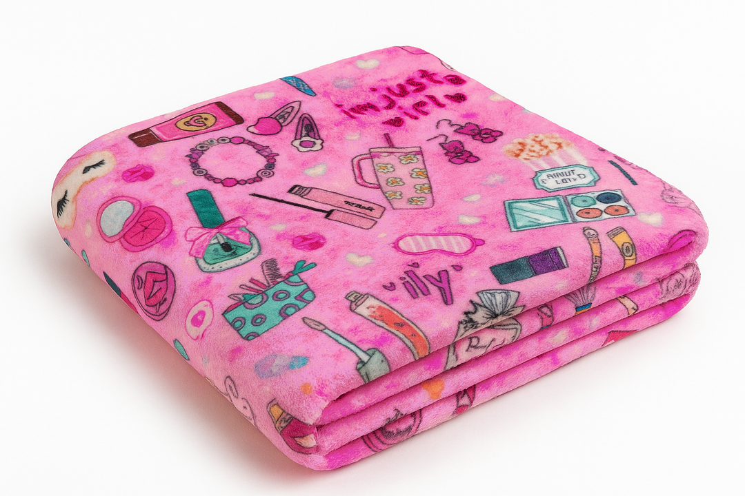 Pink plush blanket with various illustrations on a white background