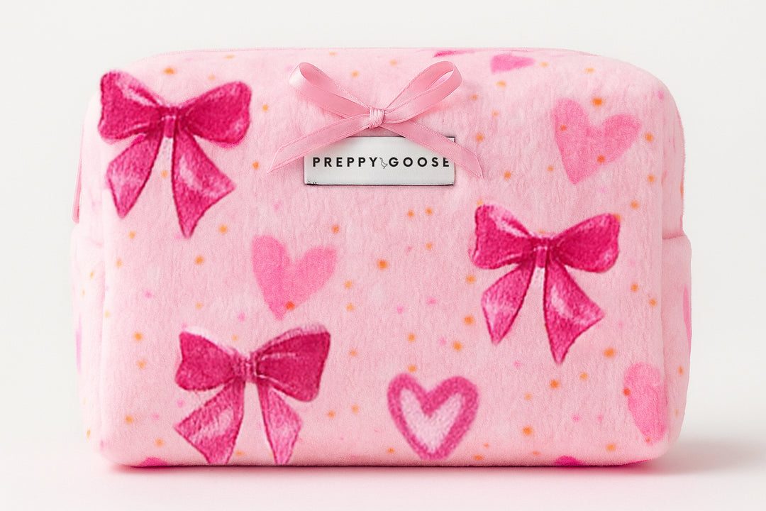 Pink pouch with bows and hearts pattern, featuring 'Preppy Goose' brand.