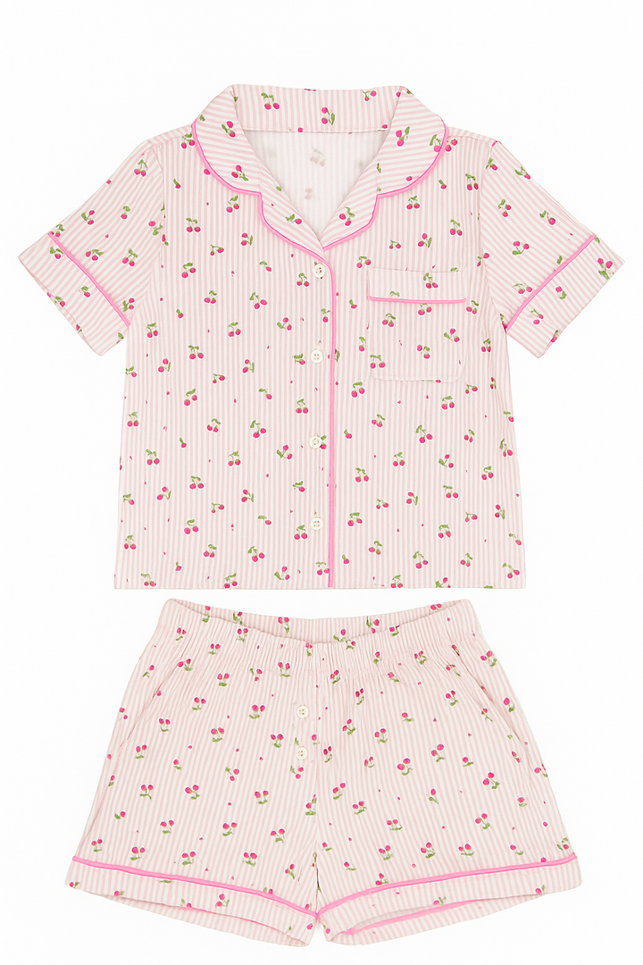 Pink and white pajama set with cherry pattern on a white background