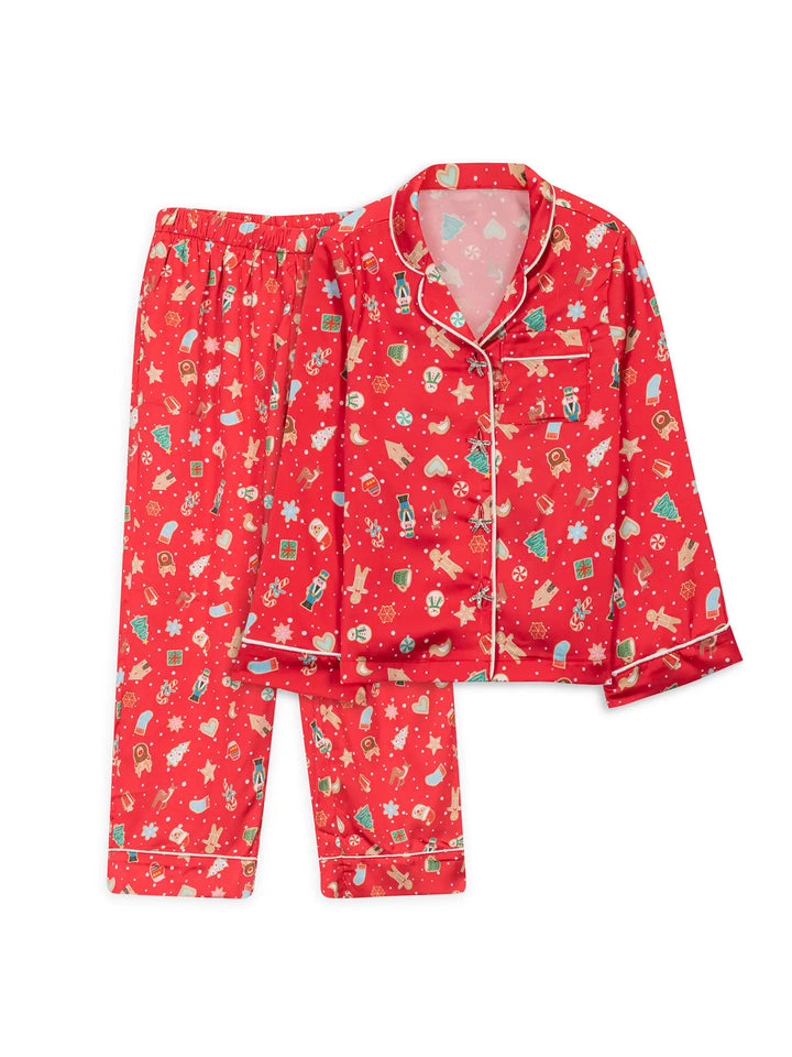 Red satin girls pajama set with festive pattern on a white background