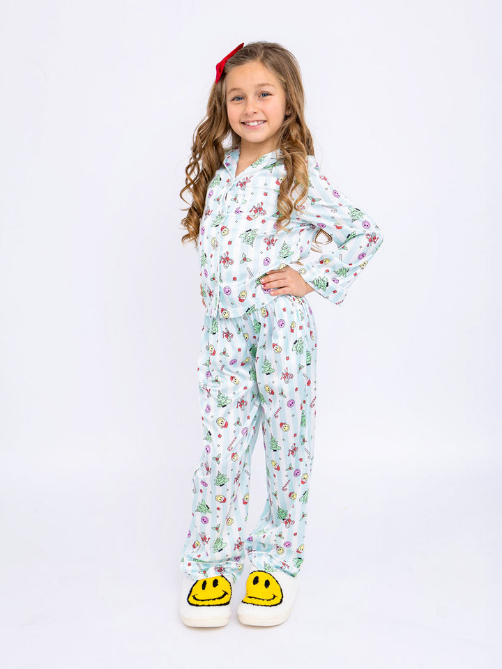 girl in festive satin holiday pajama set