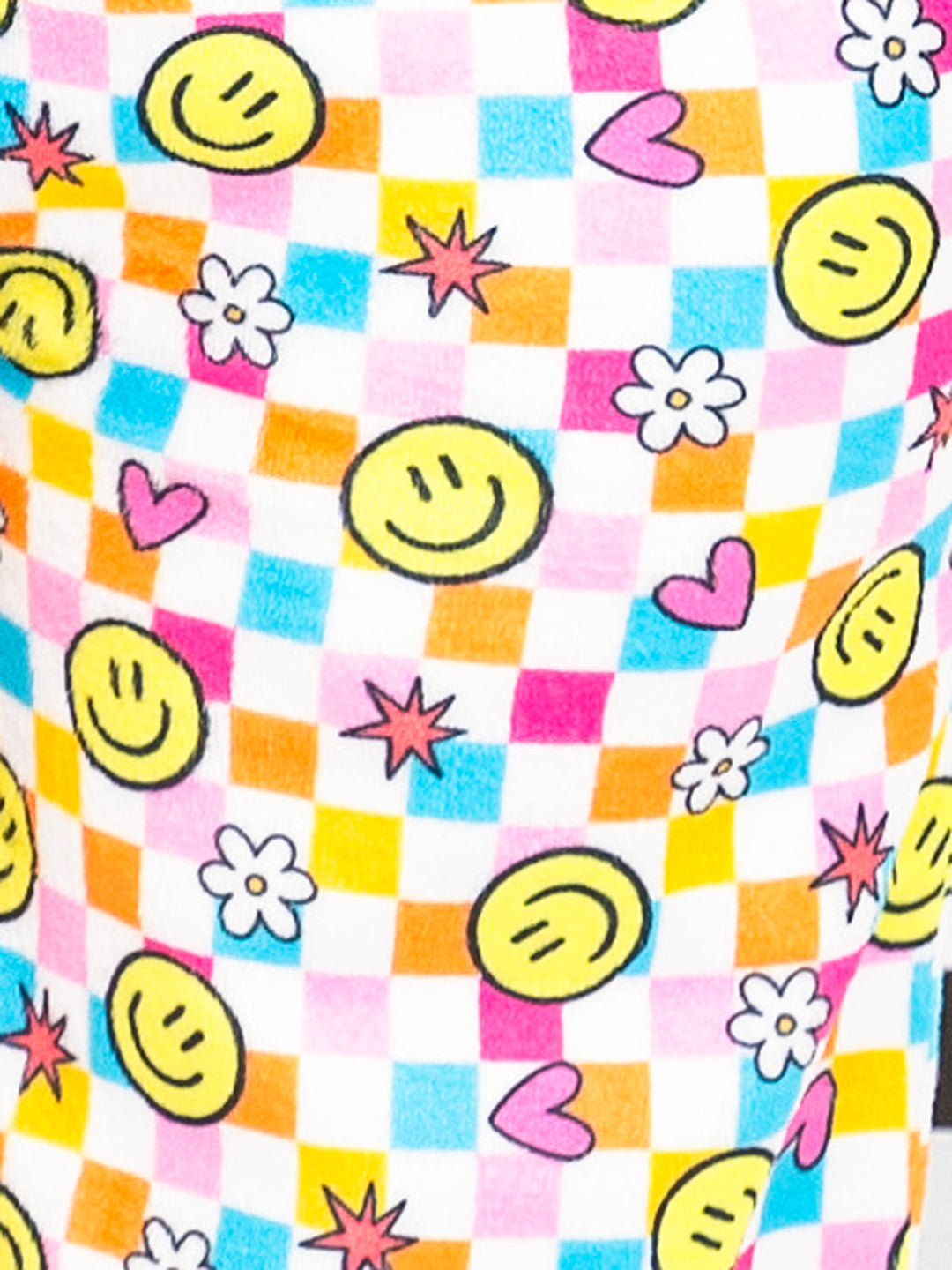 Colorful fabric with smiley faces, hearts, and flowers on a checkered background